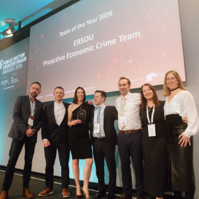 Photo - winner receiving a trophy at the Public Counter Fraud Awards
