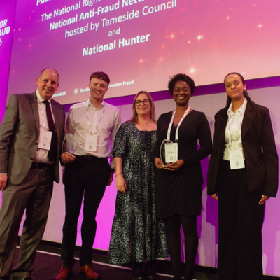 Photo - winner receiving a trophy at the Public Counter Fraud Awards