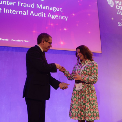Photo - winner receiving a trophy at the Public Counter Fraud Awards