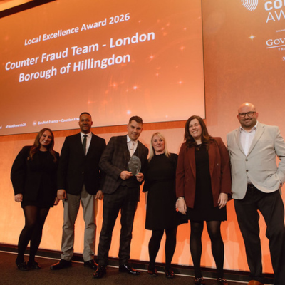 Photo - winner receiving a trophy at the Public Counter Fraud Awards