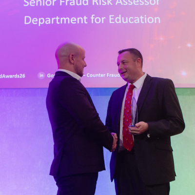 Photo - winner receiving a trophy at the Public Counter Fraud Awards