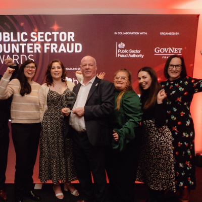 Photo - winner receiving a trophy at the Public Counter Fraud Awards
