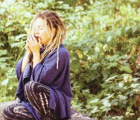Woman breathing outdoors wrapped in a blanket
