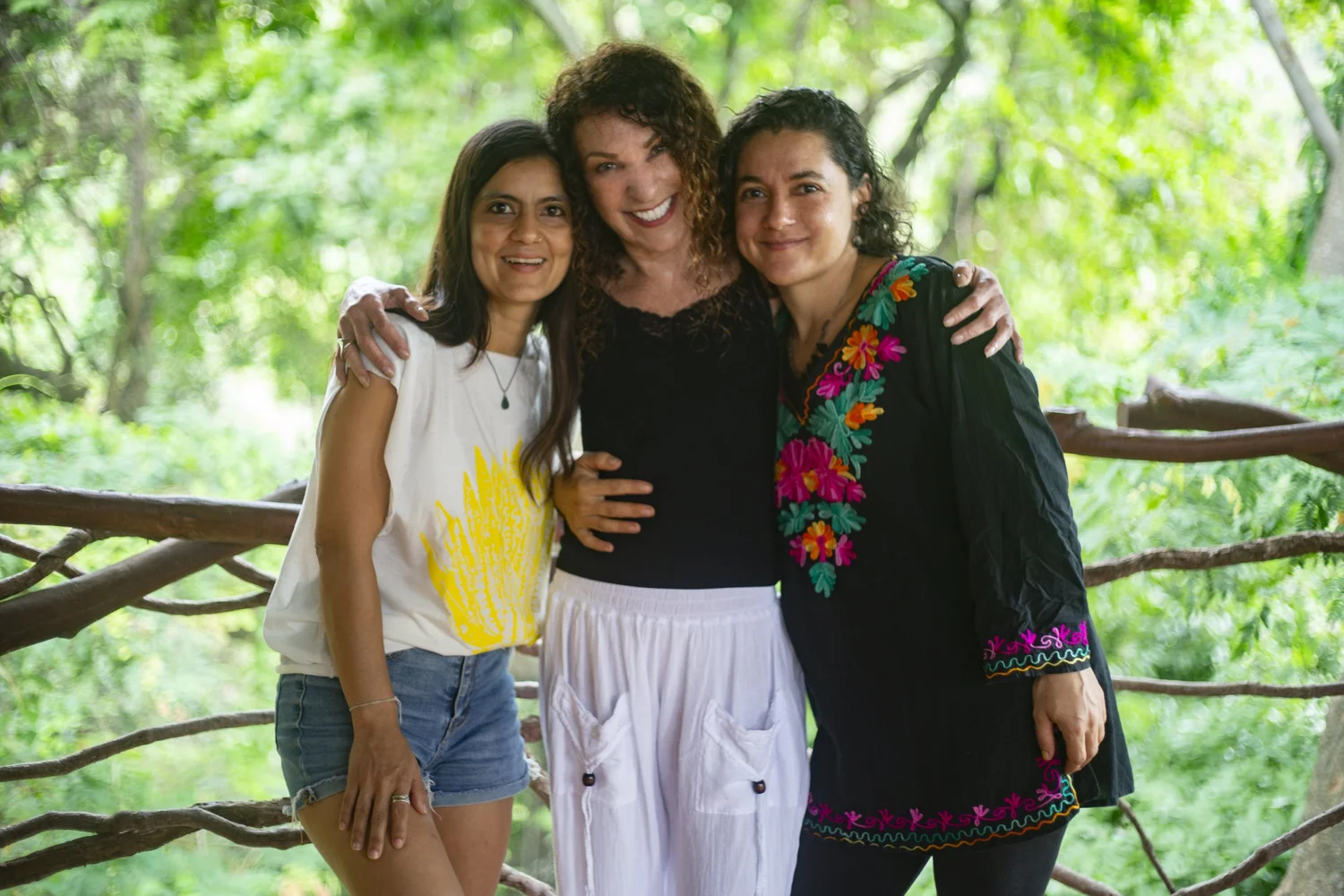 Dawn hugging two friends among the trees