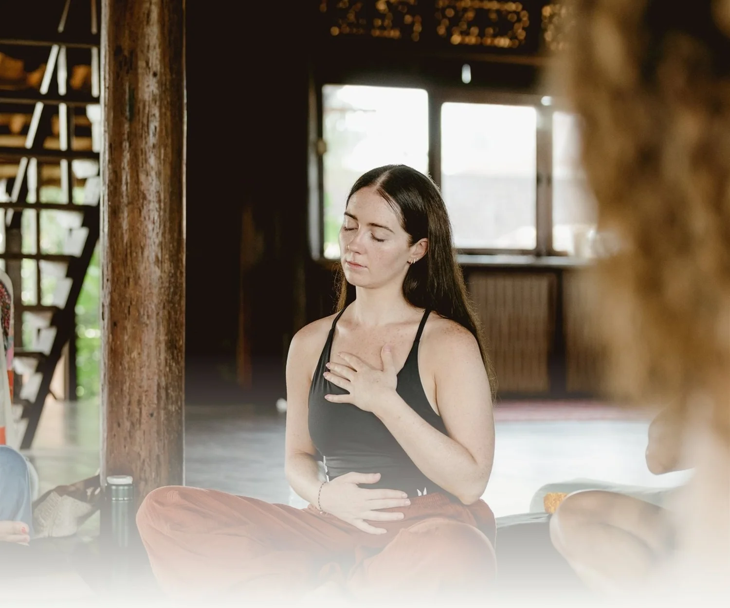 A woman breathing with one hand on her chest
