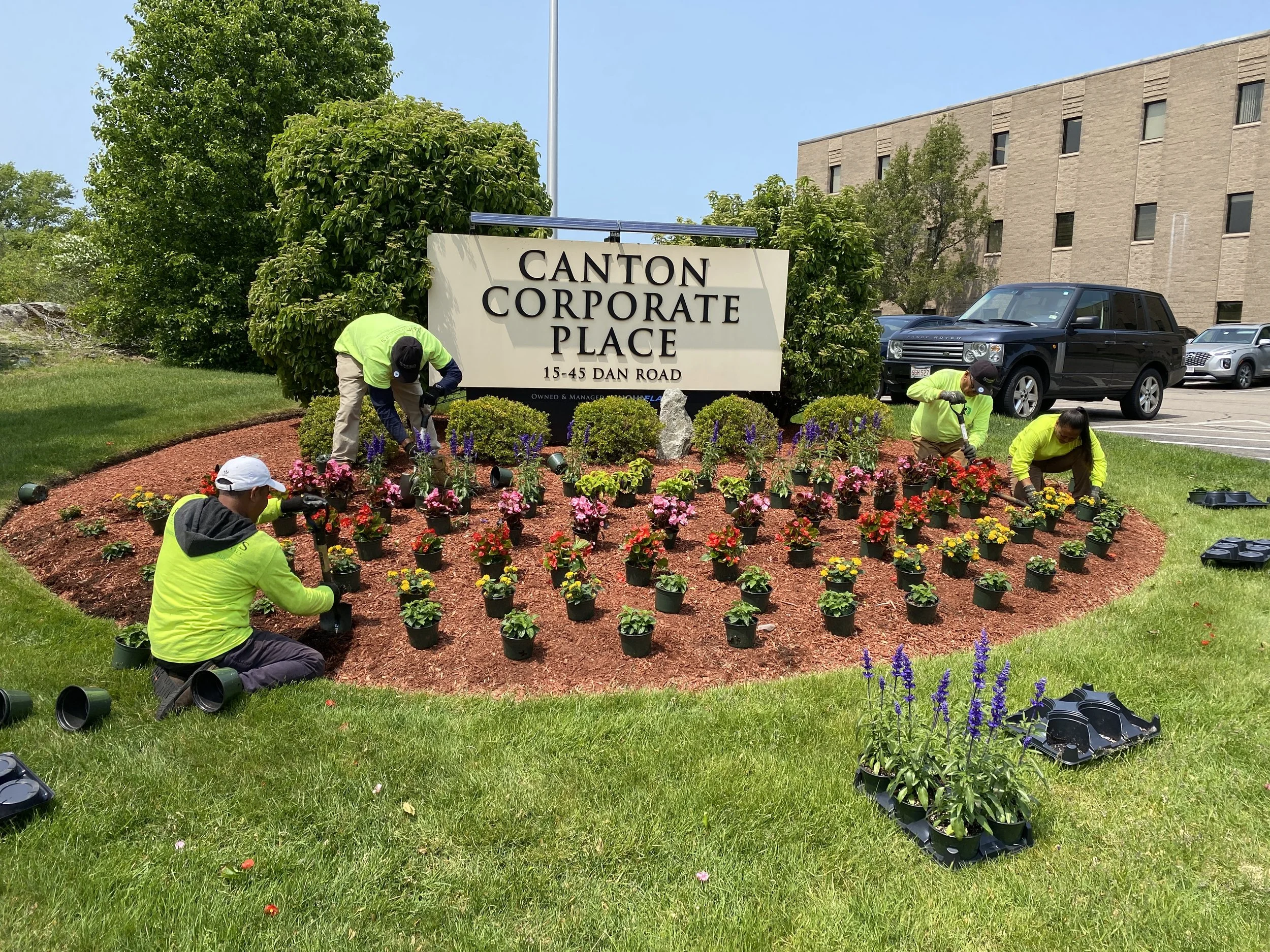 Romeiro's Landscape Management crew preparing a beautiful seasonal flower display at a local Massachusetts office park. Best commercial landscapers Boston.