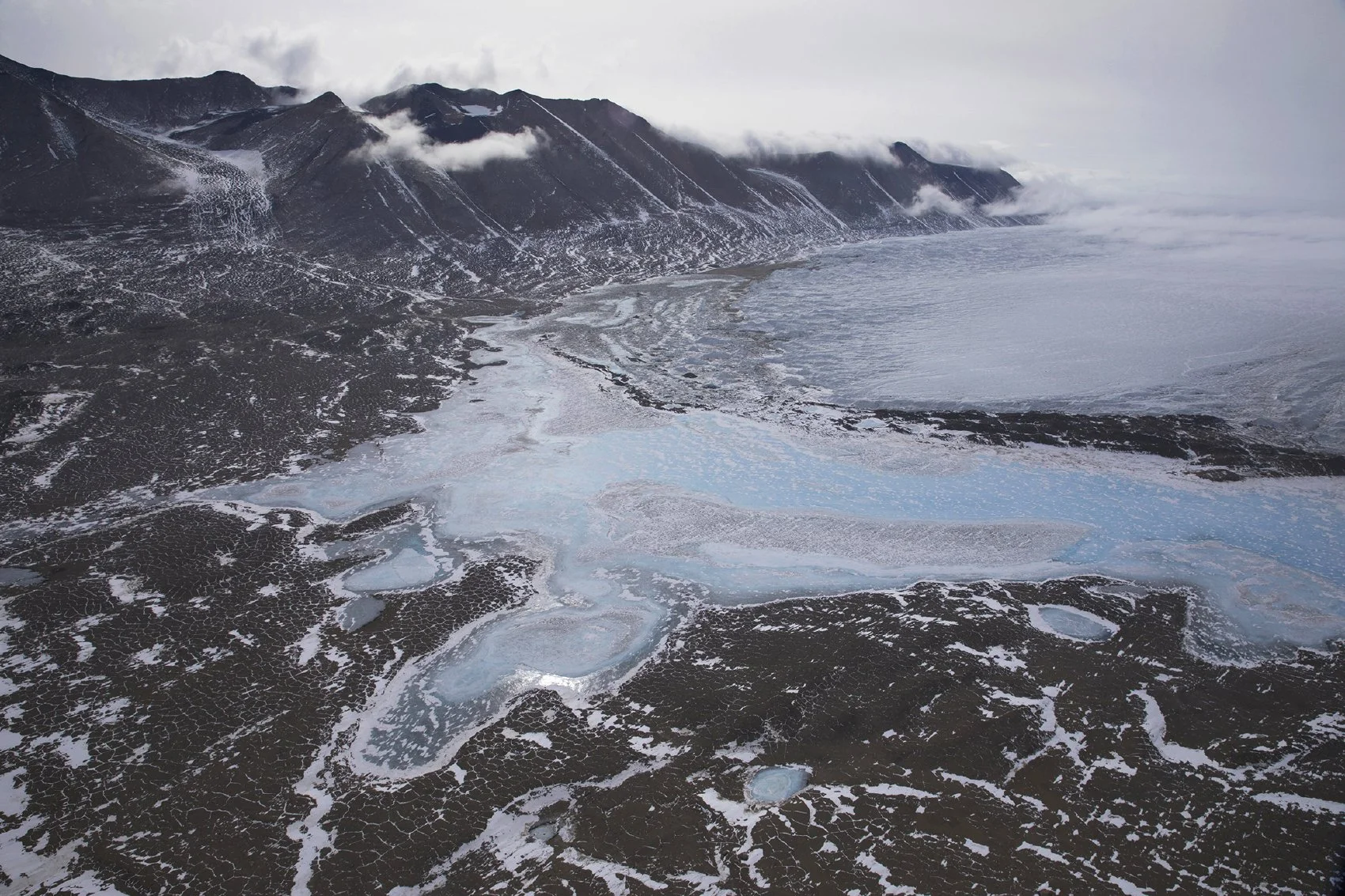 Aerial flight over serene, pristine Taylor Valley. One of Antarctica's Dry Valleys.