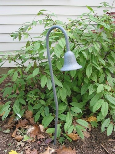 Verdigris tulip lamp to light foundation planting.