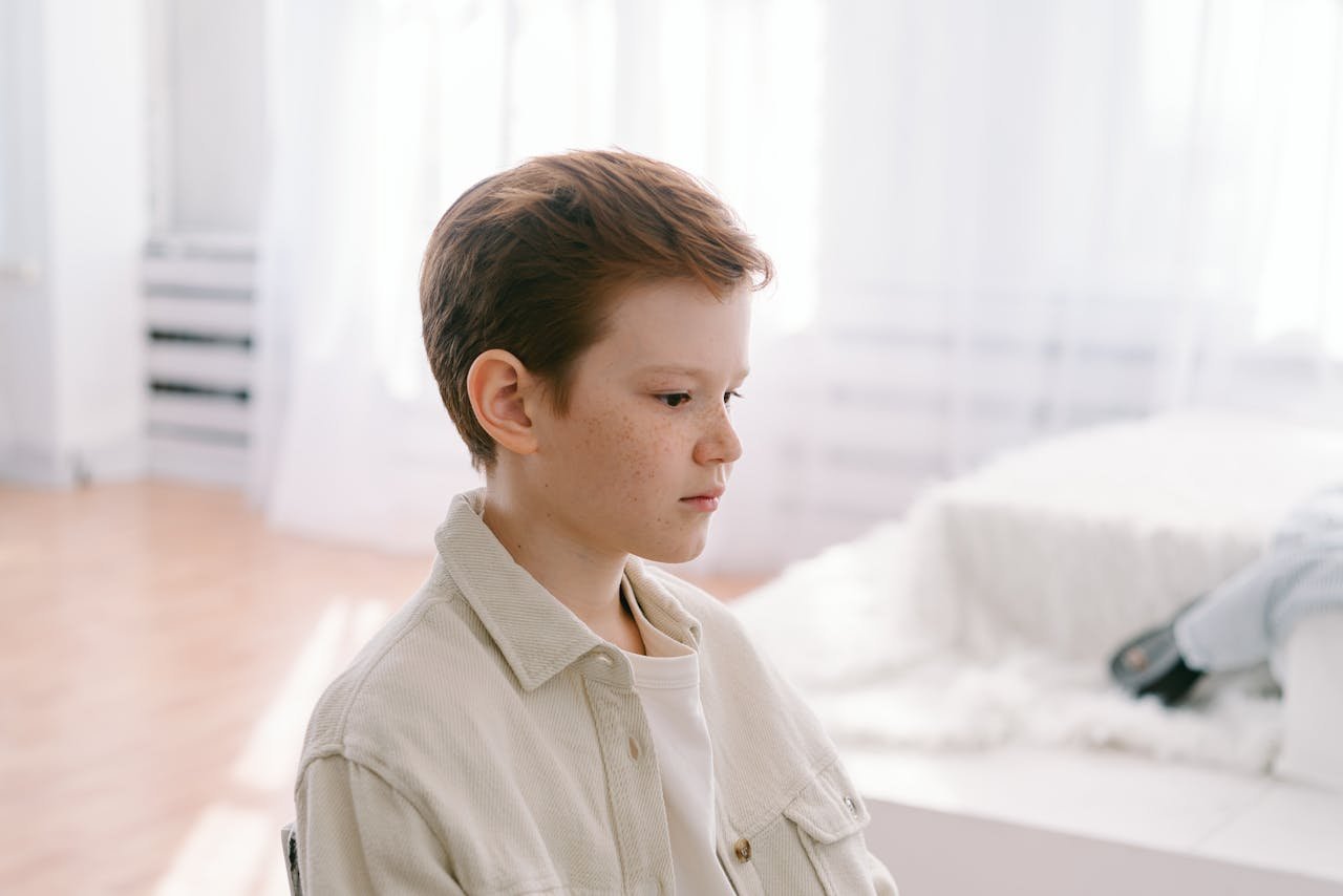 boy-in-button-down-shirt-looking-afar
