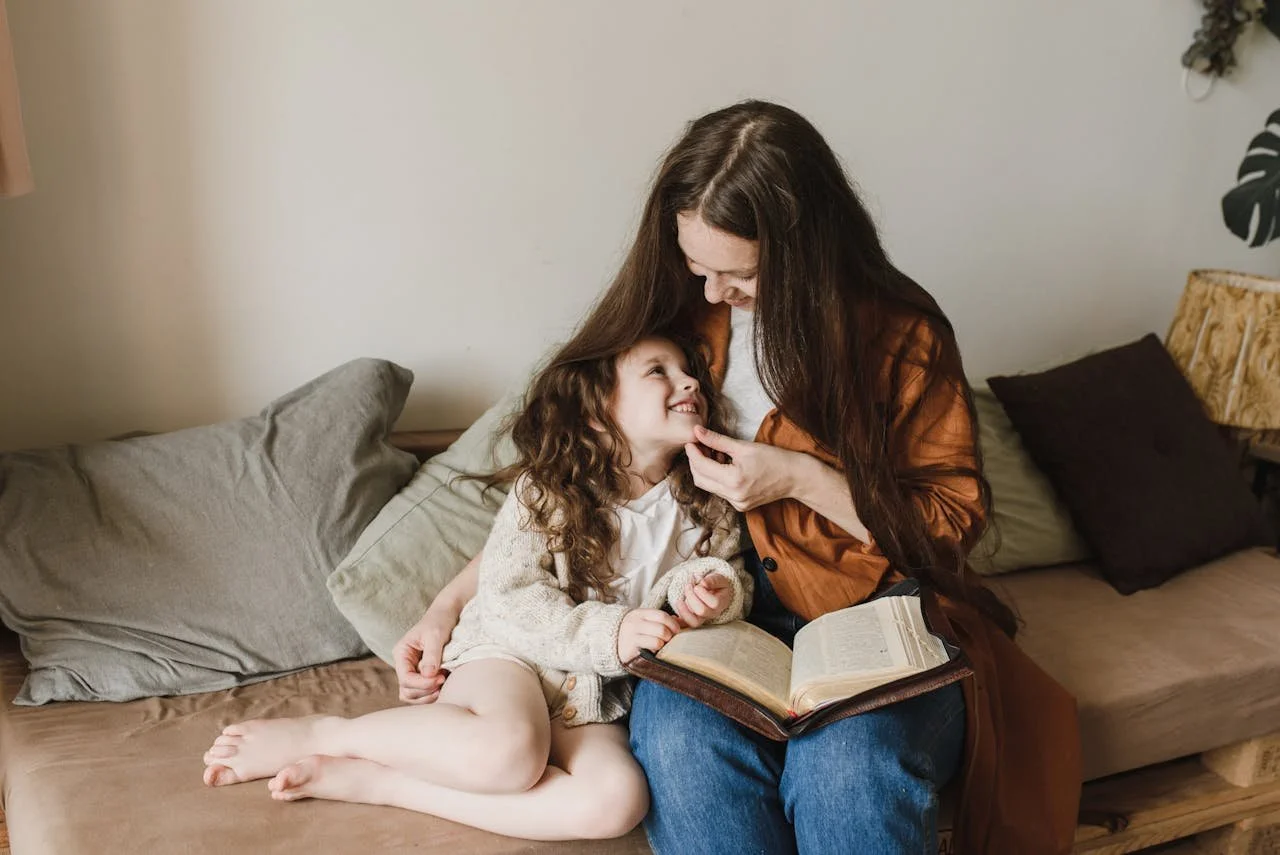 woman-and-a-child-sitting-on-a-couch-with-throw-pillows
