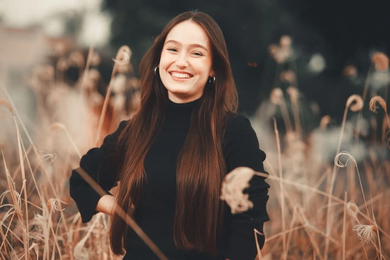 woman-in-black-long-sleeves-standing-on-grass-field