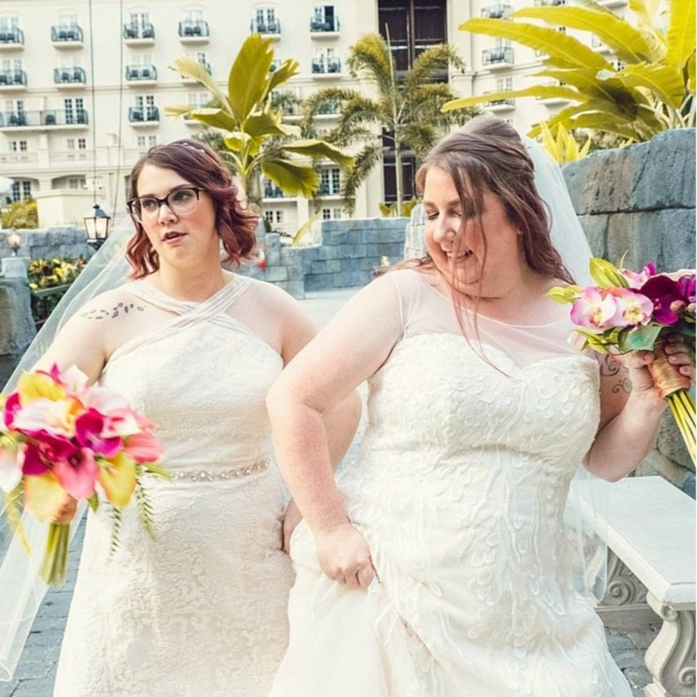 two brides silly dancing during wedding portraits taken by Sharma Shari Photography