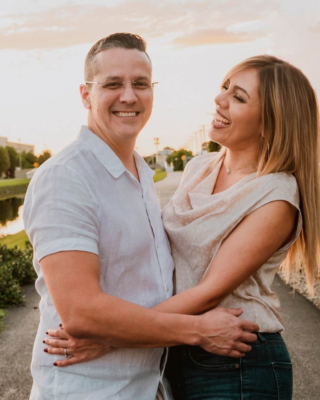 fiance smiles at fiancee during sunset hour engagement photos taken by Sharma Shari Photography
