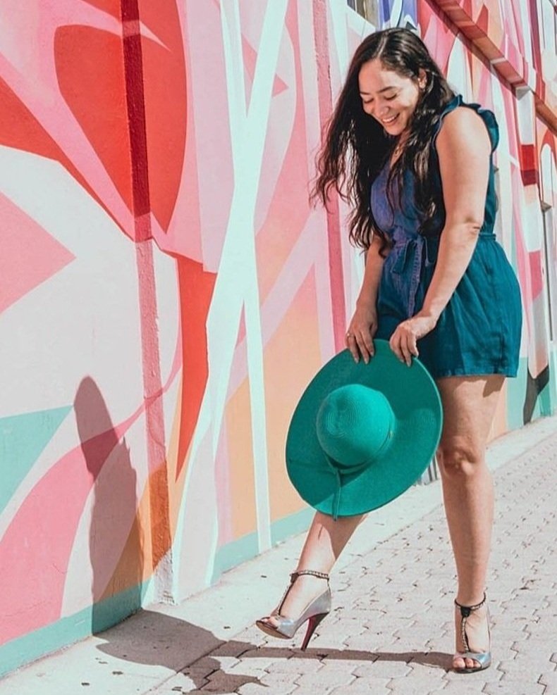 professional headshot of content creator in front of a mural in South Florida