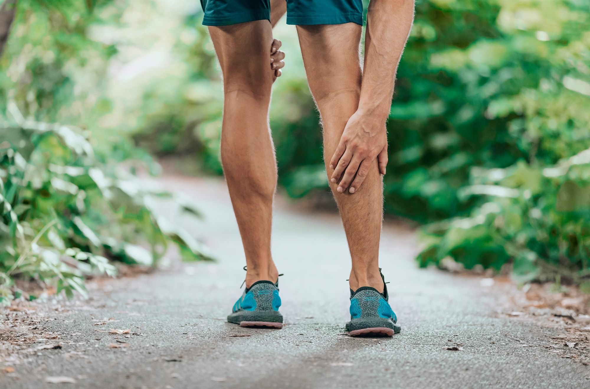 Runner checking calf soreness after a workout