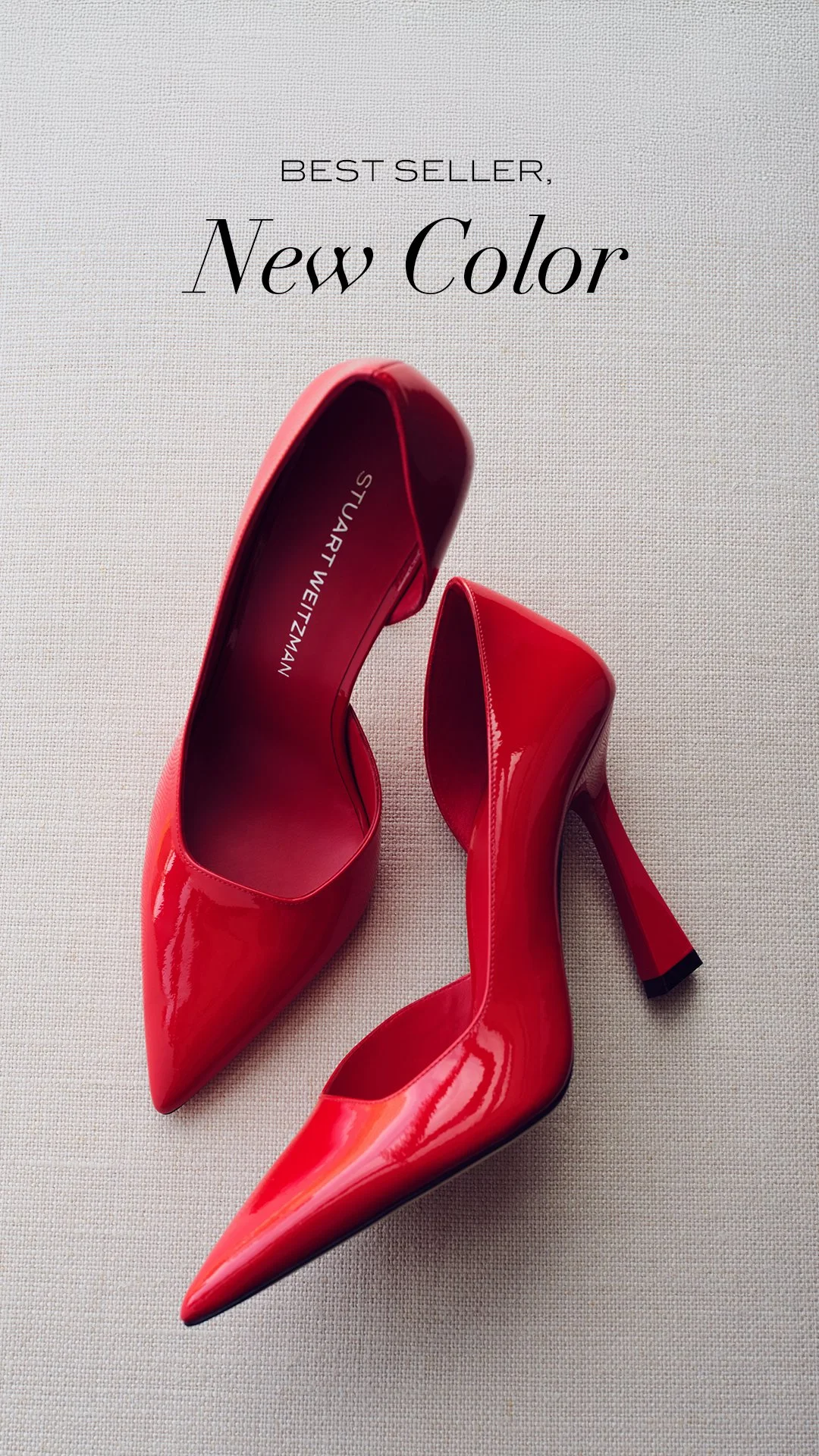 Pair of shiny red high heels on a light-colored fabric surface, with text above reading 'Best Seller, New Color'.