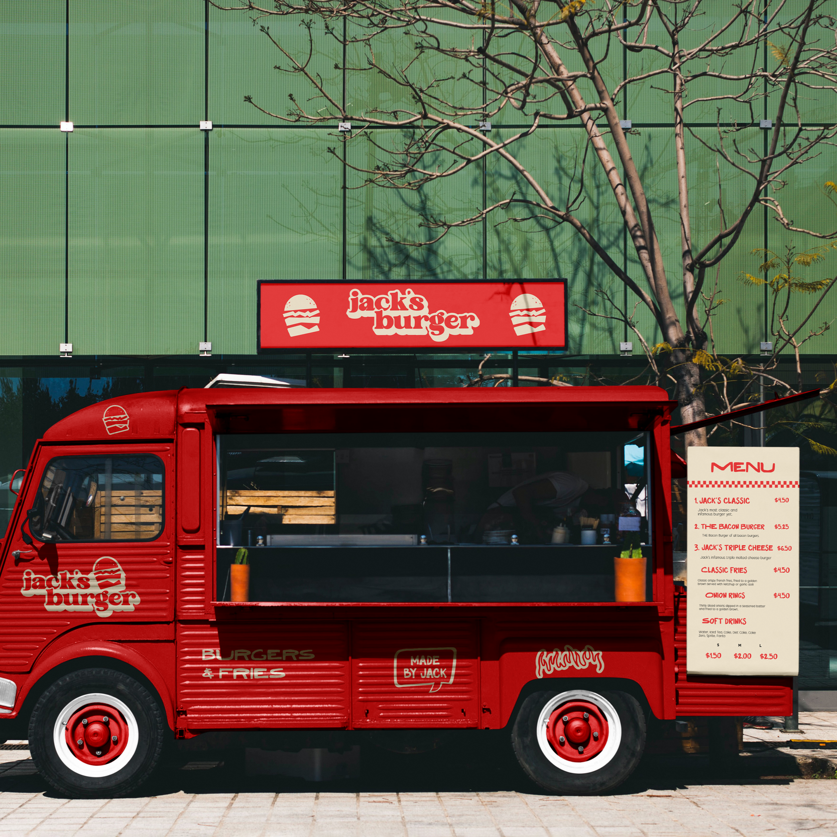 Red food truck with Jack's Burger branding parked on a sidewalk, displaying a menu board with burger options, in front of a modern glass building with a leafless tree.