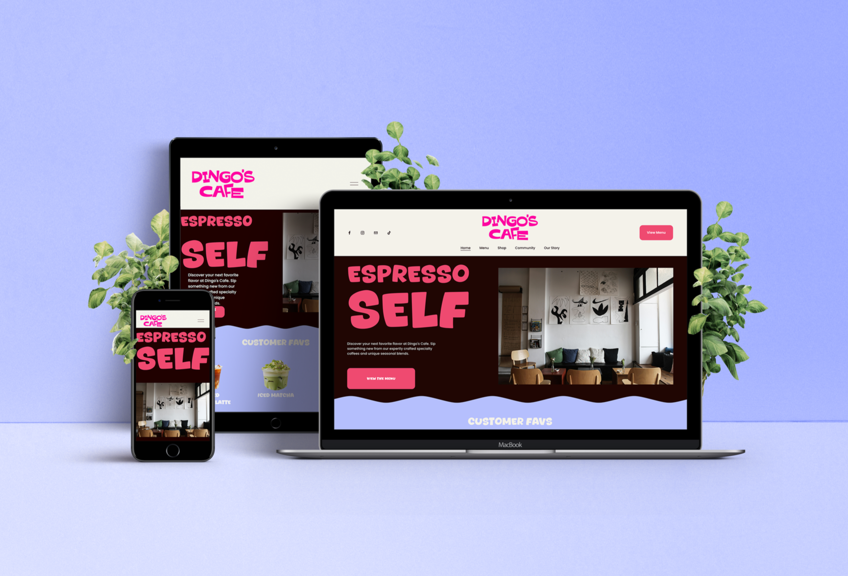 Multiple electronic devices displaying a cafe website with pink and bold text, surrounded by green plants on a pastel background.