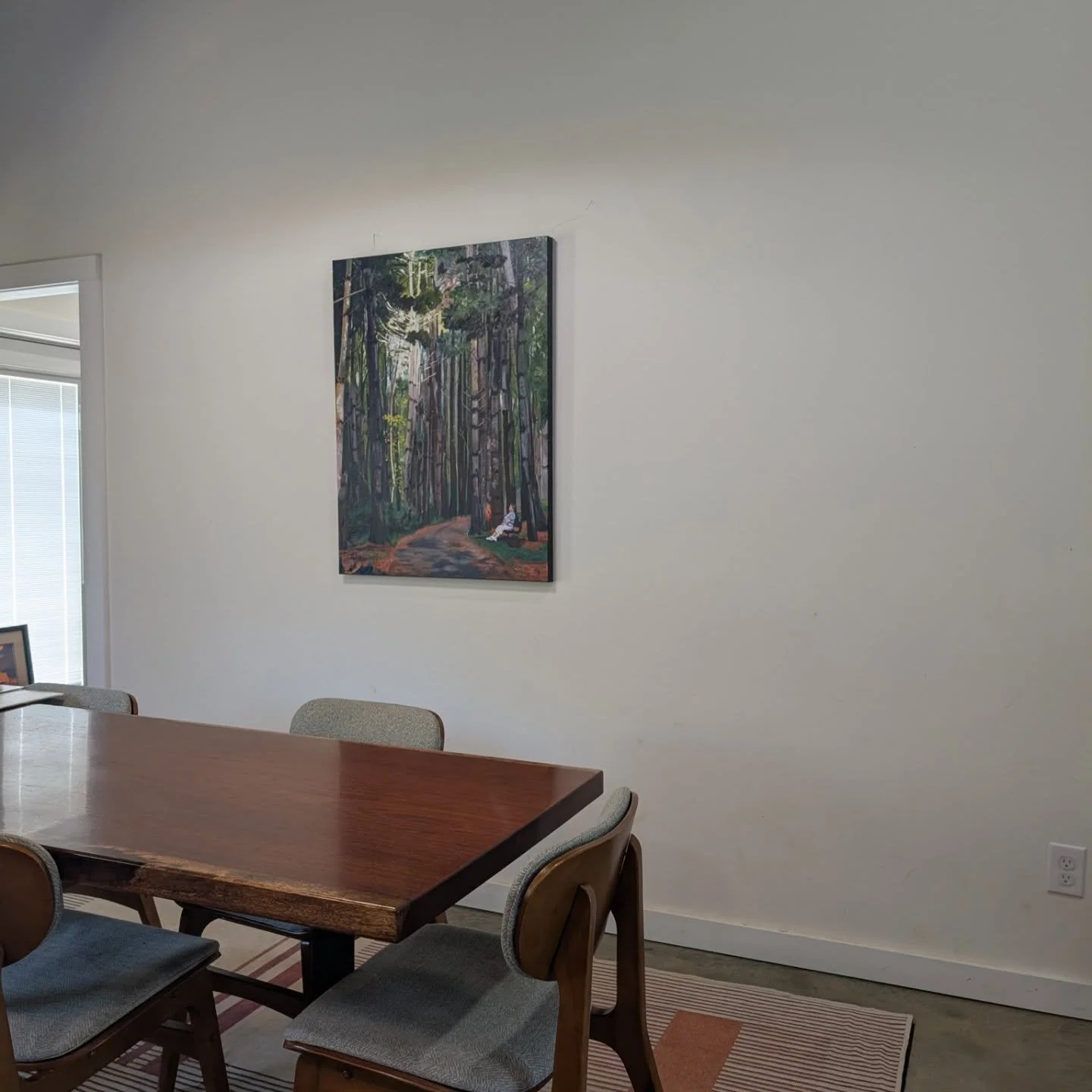 I love the way the glare hits just right on this painting in a certain position. Makes the trees look like they're glowing. Also shout-out to @blackcopperofficial for our dining room table. He does amazing work!