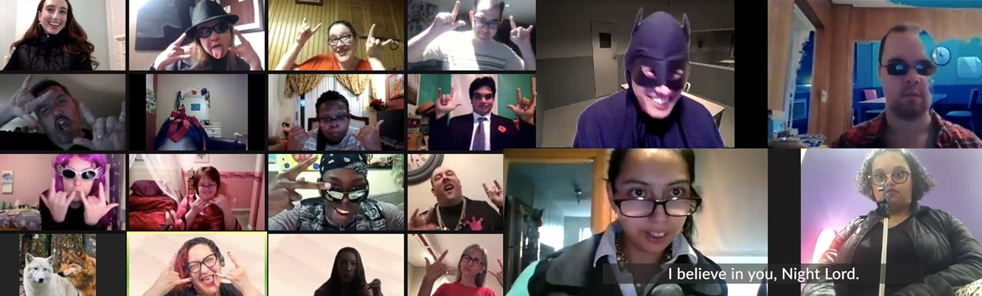 Screenshot of a DramaWay Zoom class where everyone is posing with rockstar hands. Screenshot of a DramaWay Zoom class with four actors acting out a skit, one of them wearing a batman mask, and a Zoom caption that says “I believe in you, Night Lord.”