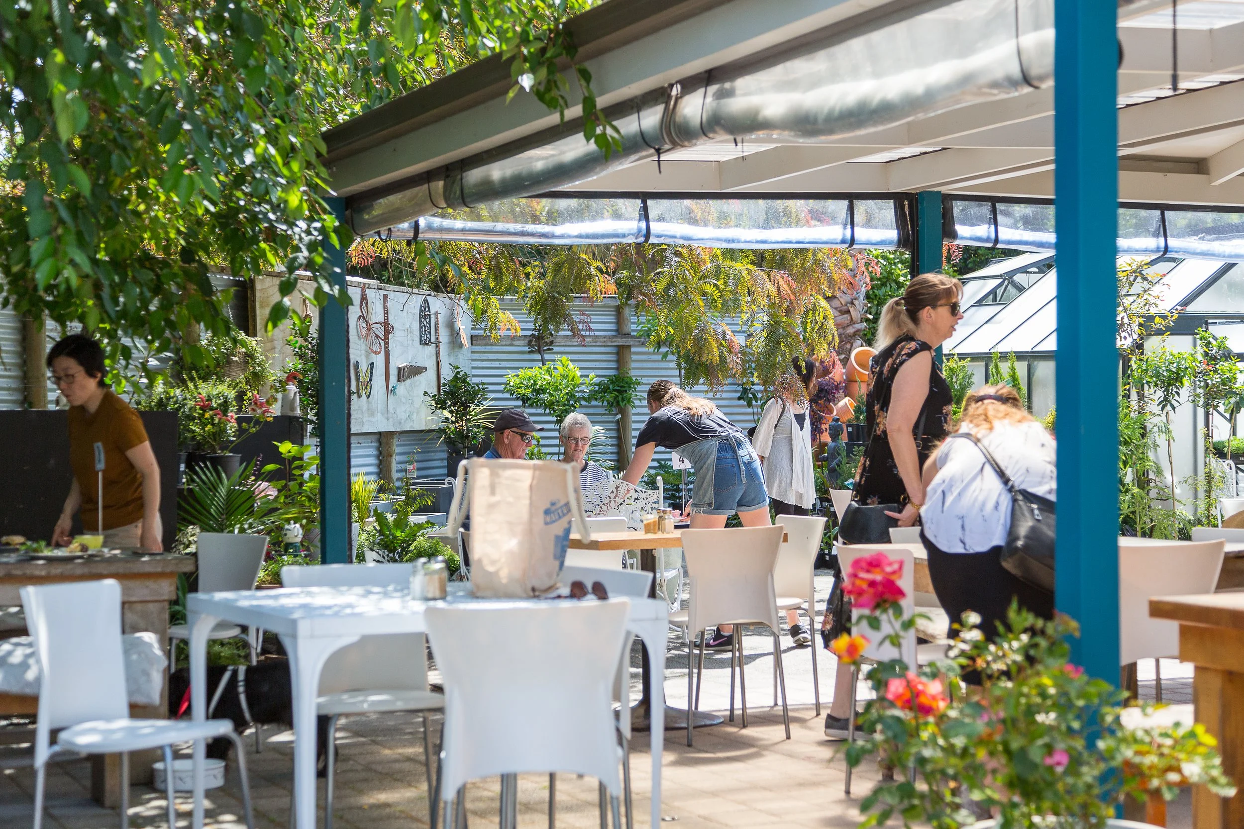 Outside seating in courtyard among trees and flowers