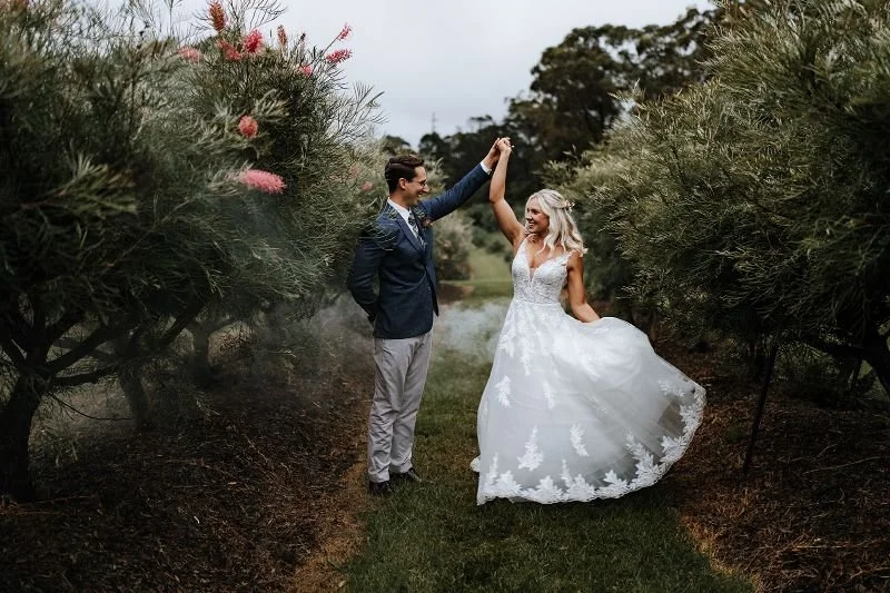 Bride and groom dancing in a lush garden
