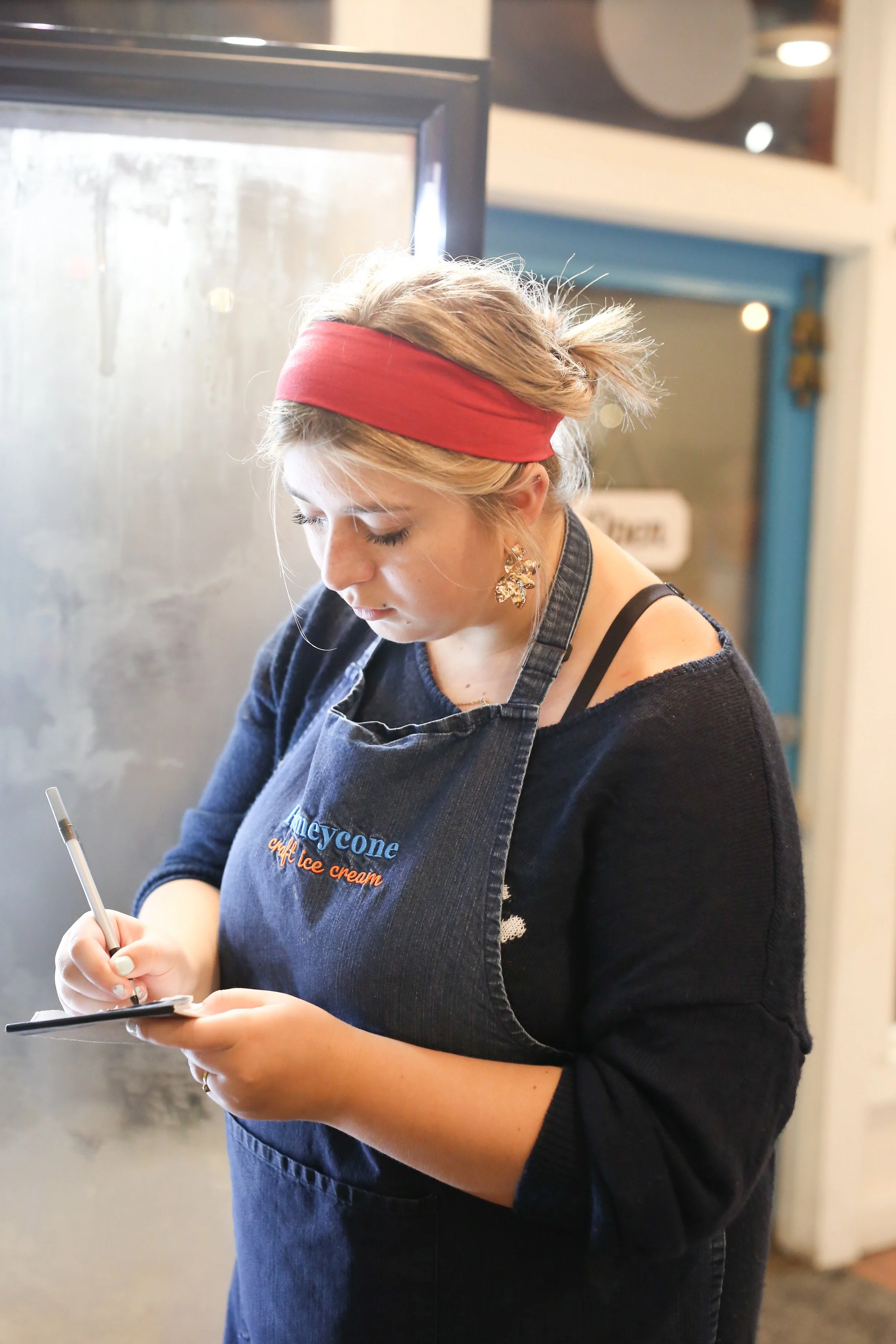 Person kneading dough on a floured surface.