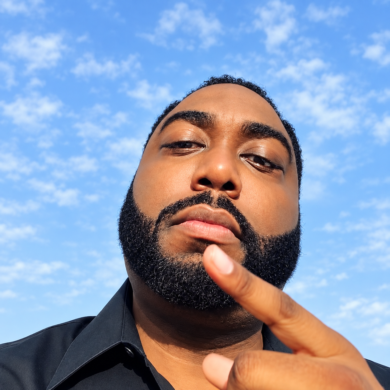 Confident Bearded Selfie Under Blue Skies.png
