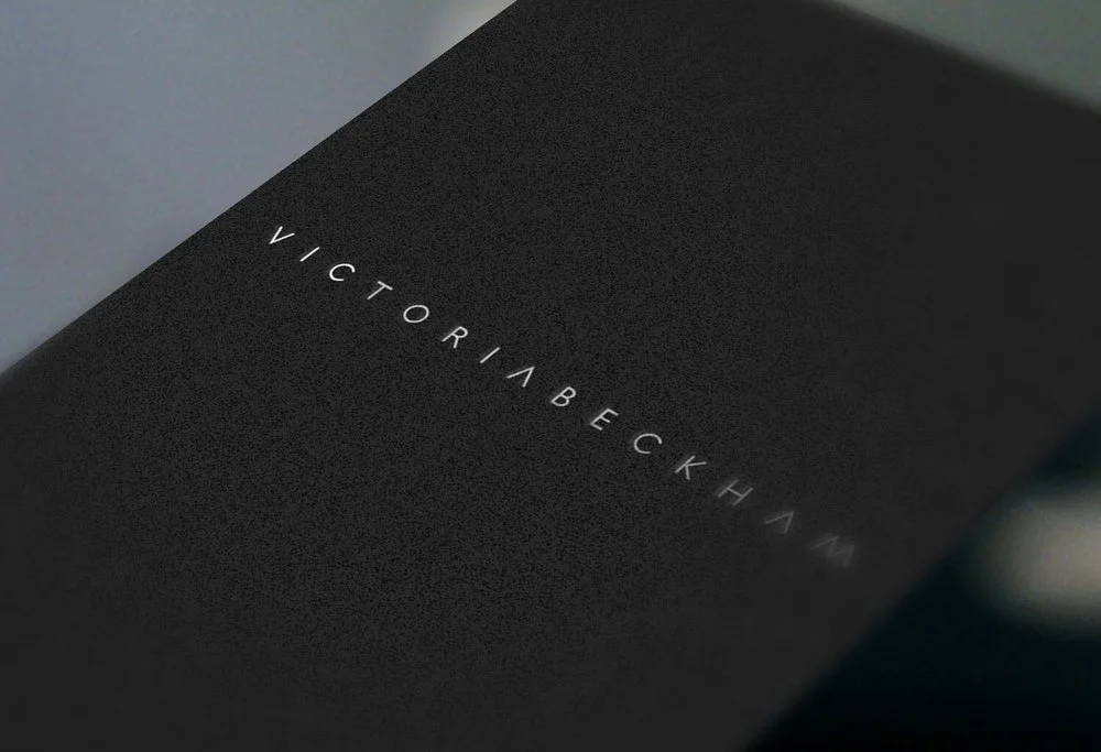 Close-up of a black book cover with the title 'Victoria Beckham' embossed in white, minimalist font.