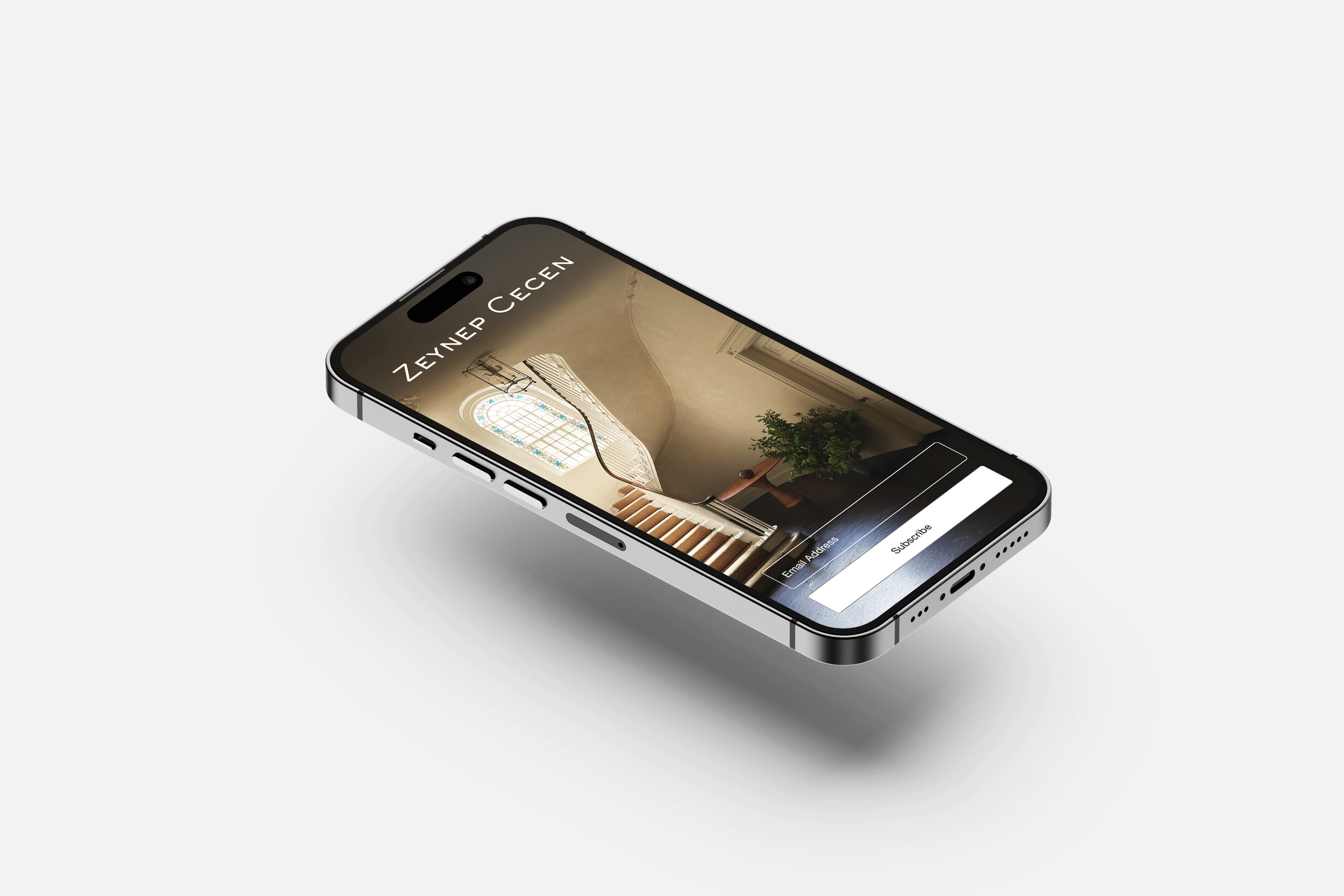 Smartphone displaying a webpage with a staircase and a plant in an elegant interior.