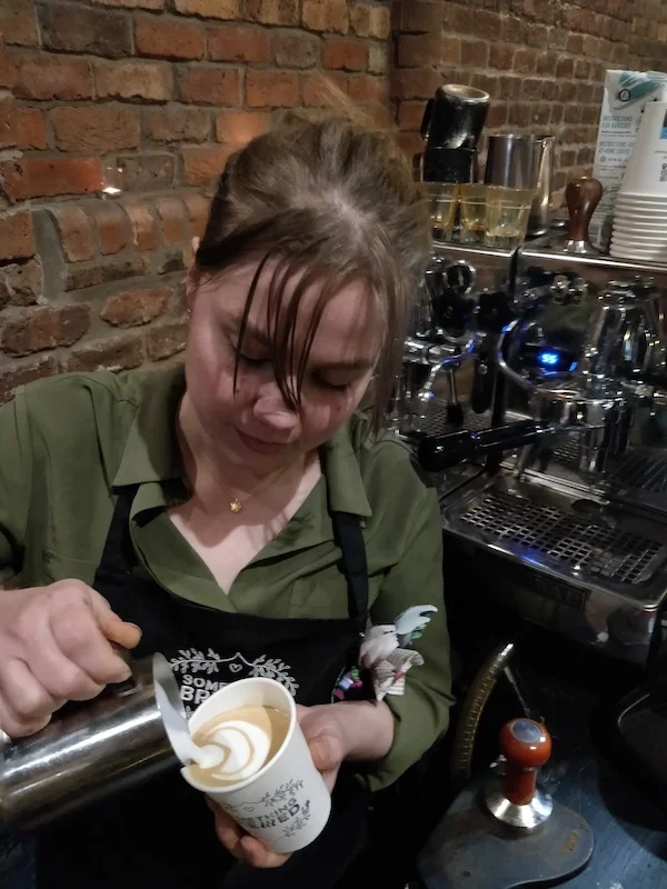 Barista serving coffee to guests at hotel wedding venue
