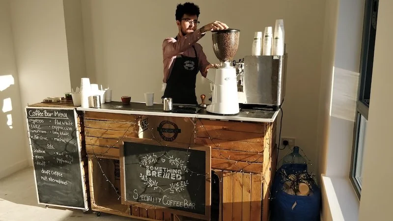 Modern office coffee station with espresso machine and barista