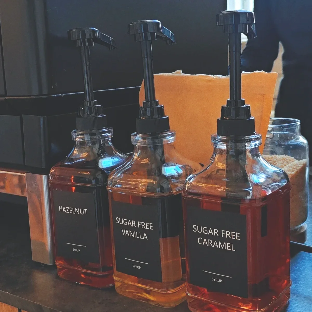 Selection of coffee syrups used to customise drinks at a specialty mobile coffee bar.