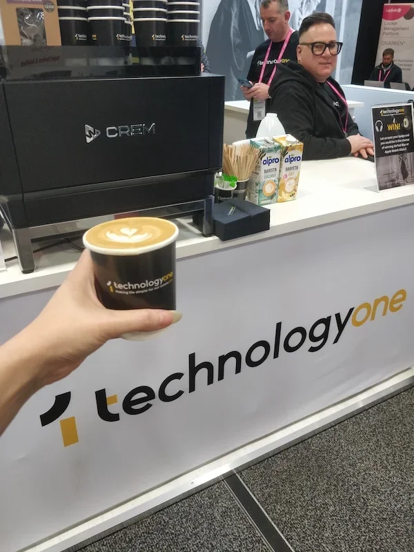 Branded coffee cups displayed on exhibition stand