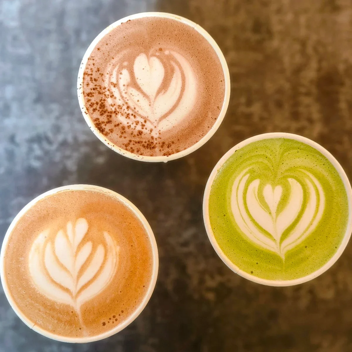 Range of specialty coffee drinks including latte art served from a mobile coffee bar.