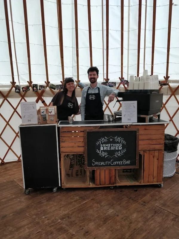 Rustic wedding coffee bar inside decorated marquee