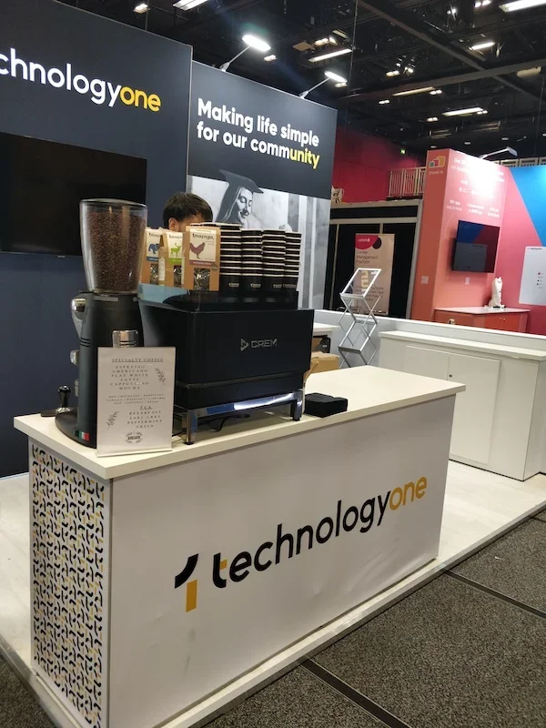 Commercial espresso machine in use at exhibition coffee bar