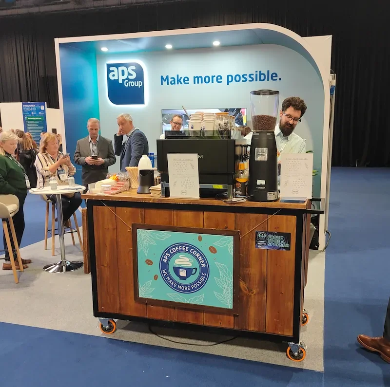 Employees interacting with barista behind mobile coffee bar