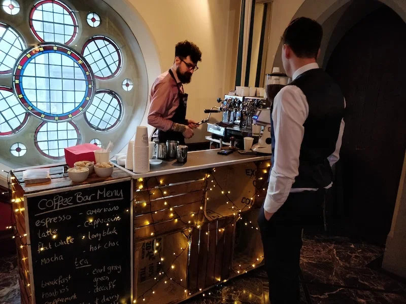 Wedding guests enjoying fresh coffee at mobile coffee bar