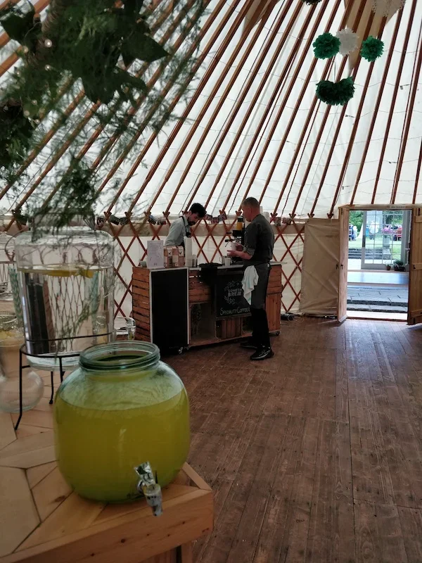 Mobile coffee bar serving wedding guests inside marquee venue