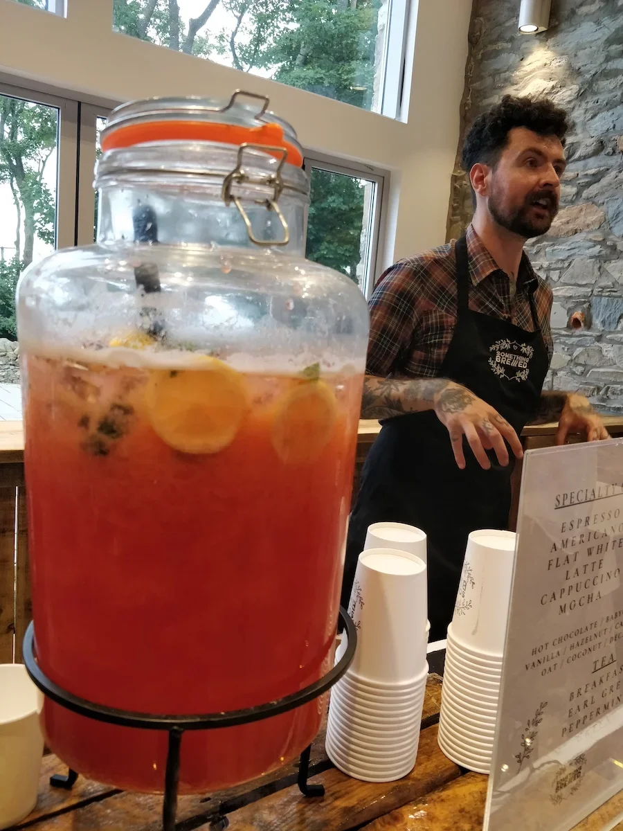 Custom requested raspberry lemonade served at wedding reception drinks station