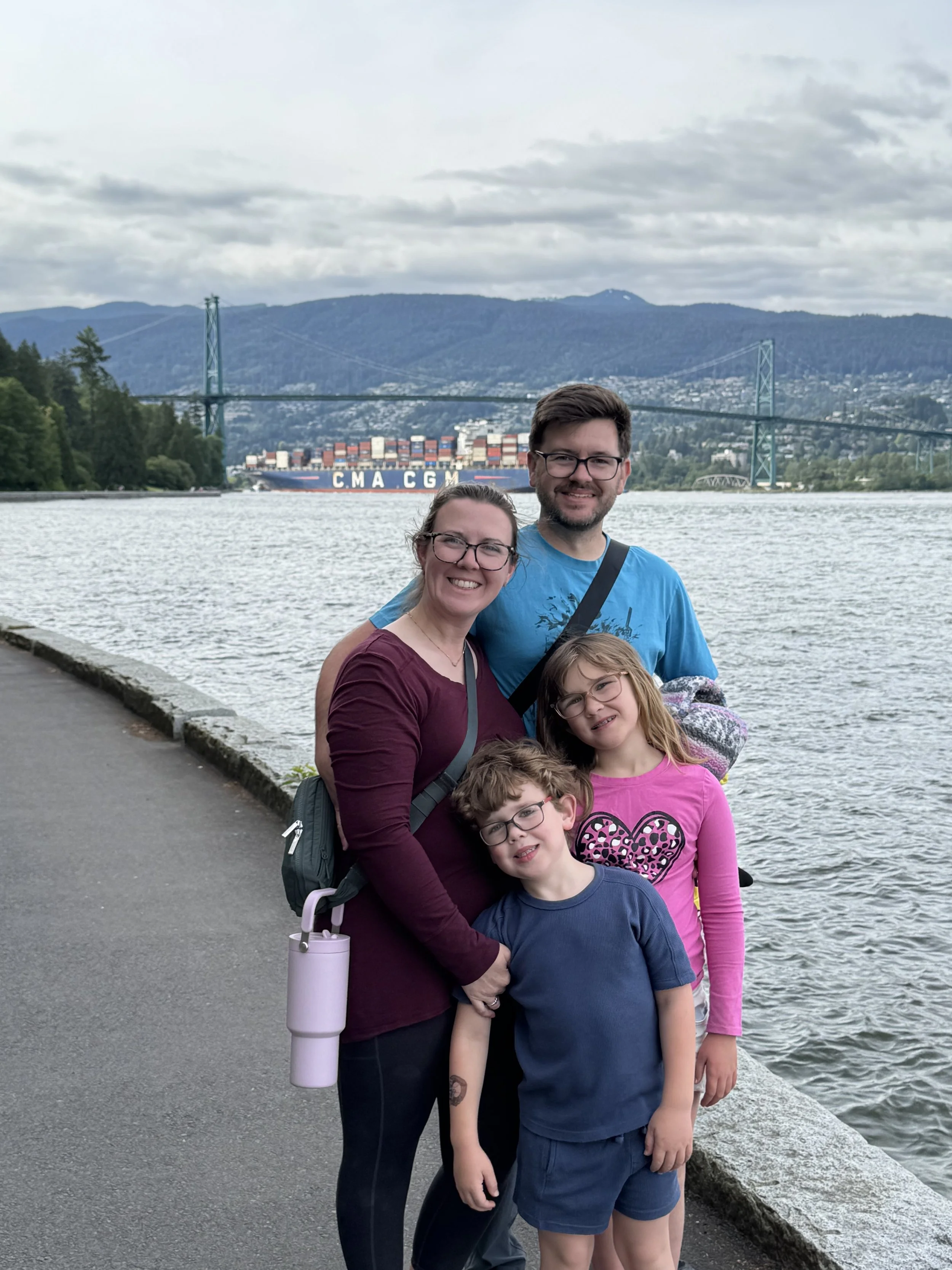 Family in Stanley Park, Vancouver with Lions Gate Bridge in the background.
