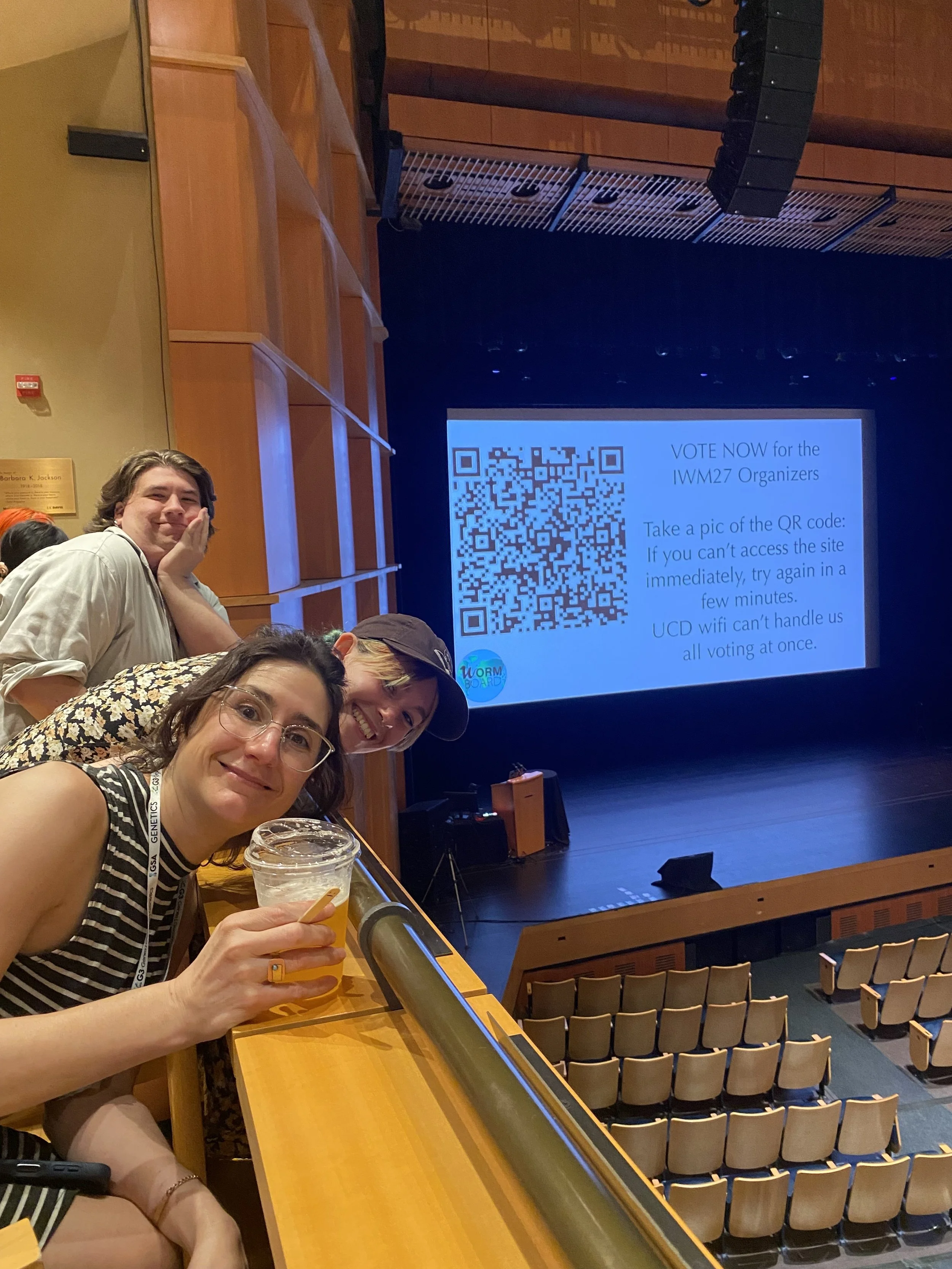 July 2025: Kim lab members Amelia Alessi, Victoria Murphy, and Joe Dixon settle in to enjoy the time-honored comedy show at International Worm Meeting at UC Davis.