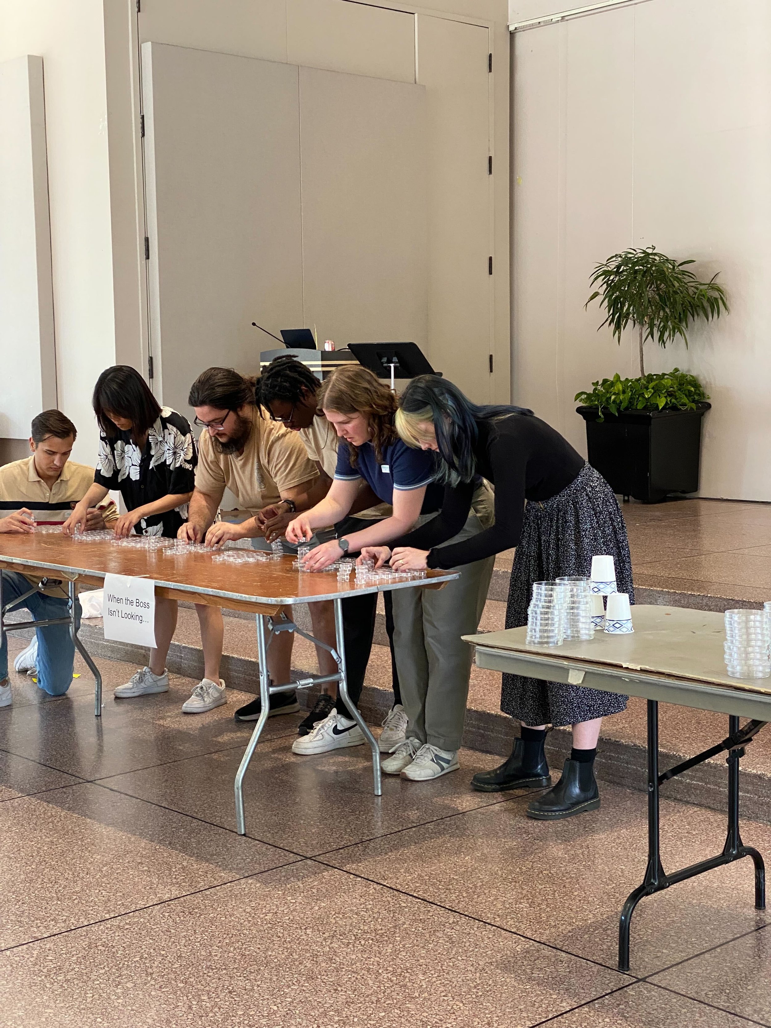 August 2025: Kim Lab member Victoria Murphy (right) heroically stacks worm plates in the final relay competition of Wormlympics.