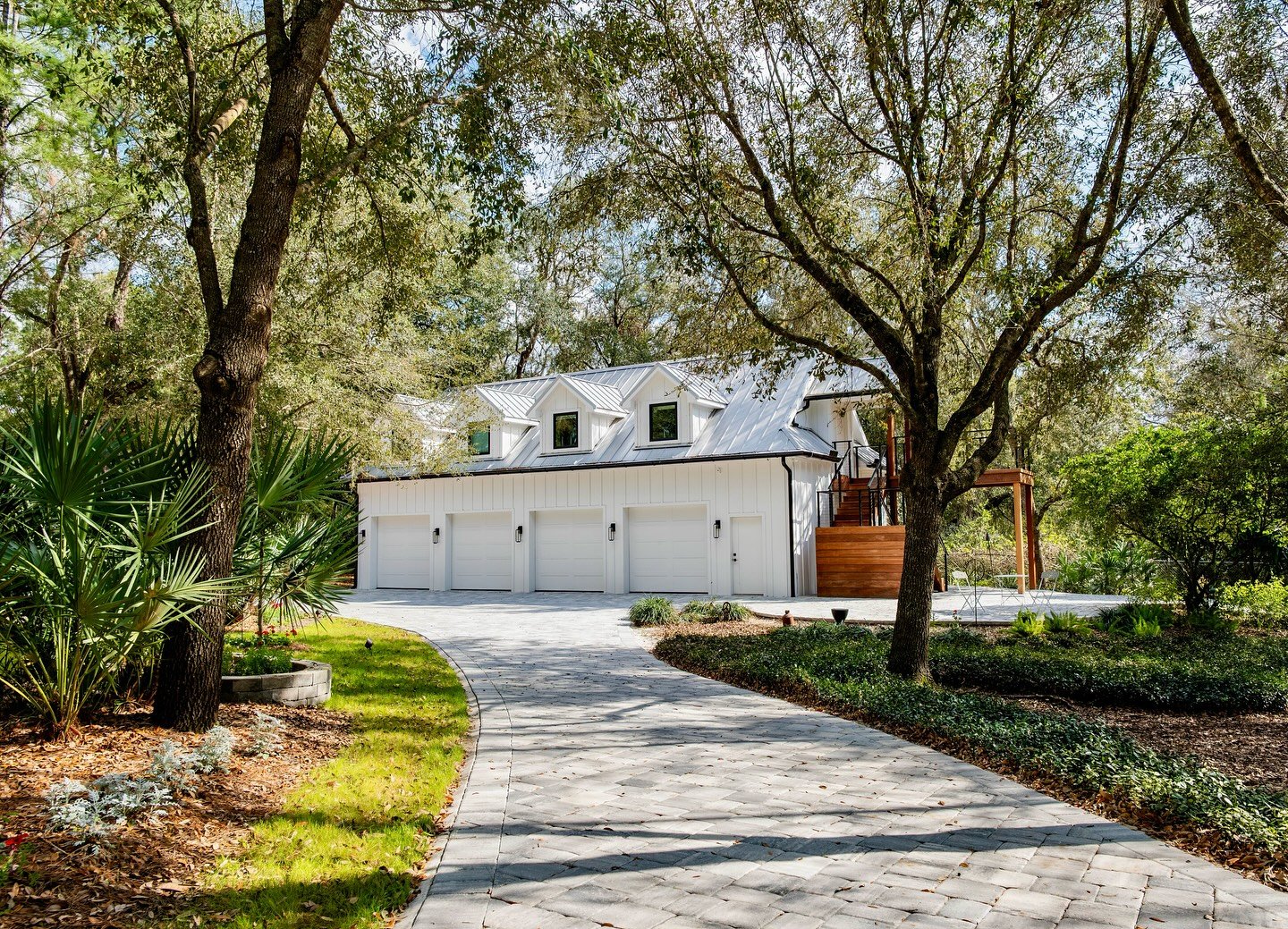 This custom 4-car garage was designed and built to complement the main home with clean lines, durable materials, and thoughtful details throughout. From the standing seam metal roof to the board-and-batten siding, every element blends elevated style 