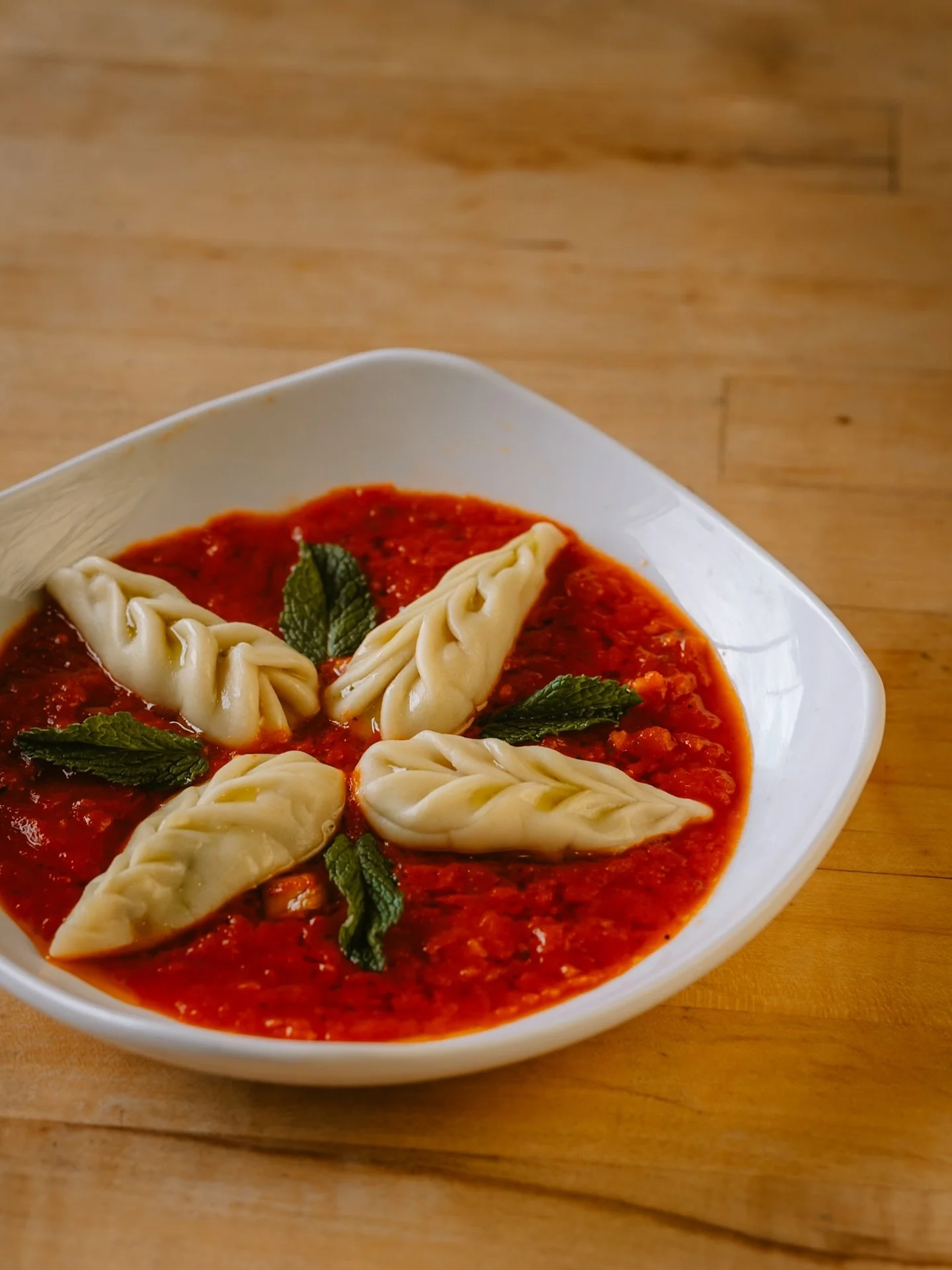 Culurgiones
A Sardinian dumpling filled with potato, mint, garlic, and olive oil. Served in our house marinara that we blend until smooth. Jared makes all of these dumplings in house, rolling the pasta by hand. Finished with a little pecorino on top.