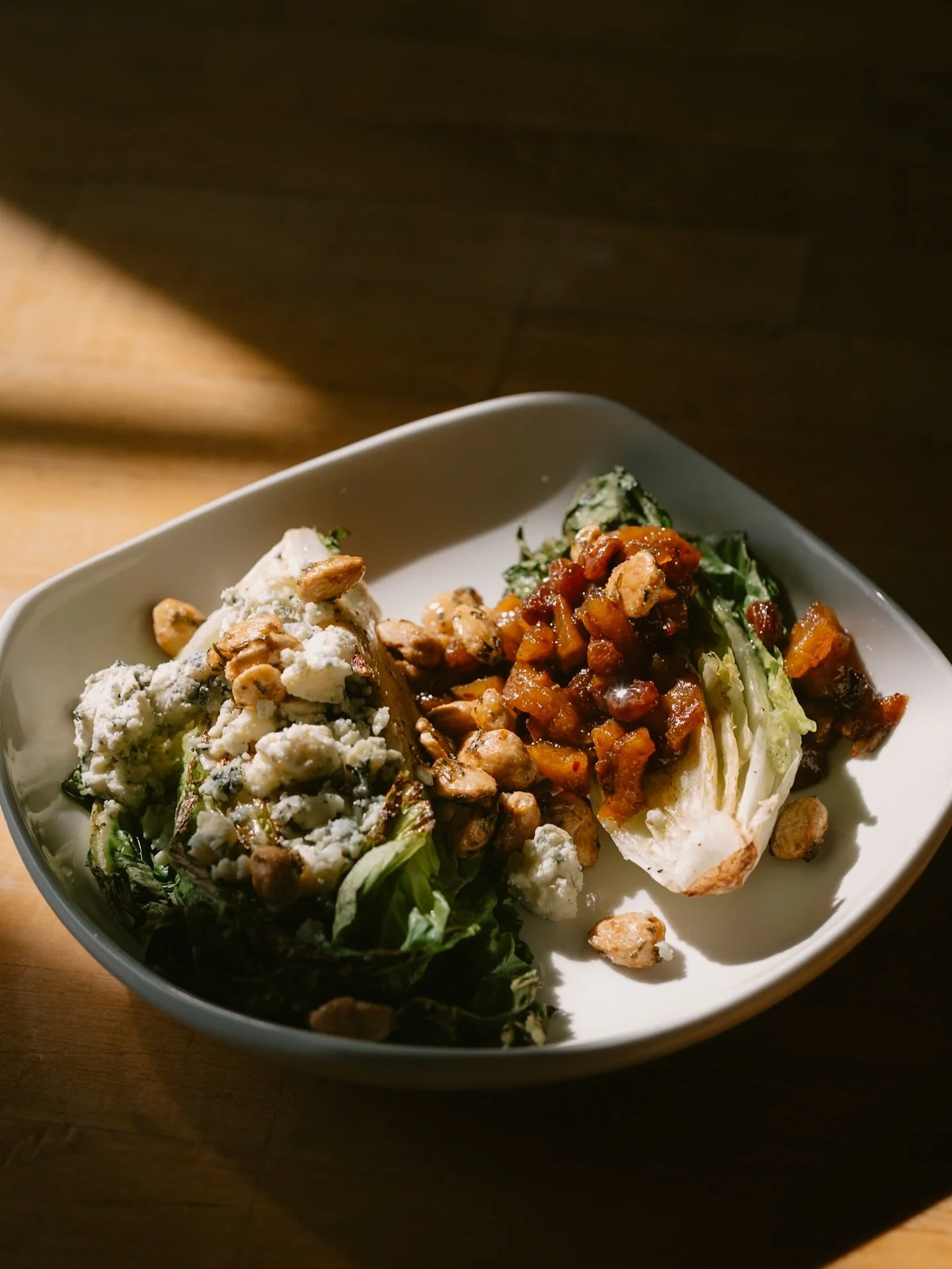 Grilled Little Gem Salad
This is inspired by a wedge salad served at a restaurant Chef Erin worked at 25 years ago. Ours is a sophisticated take, with little gem instead of iceberg, salty, creamy gorgonzola, and tangy pear chutney. Get a bite of lett