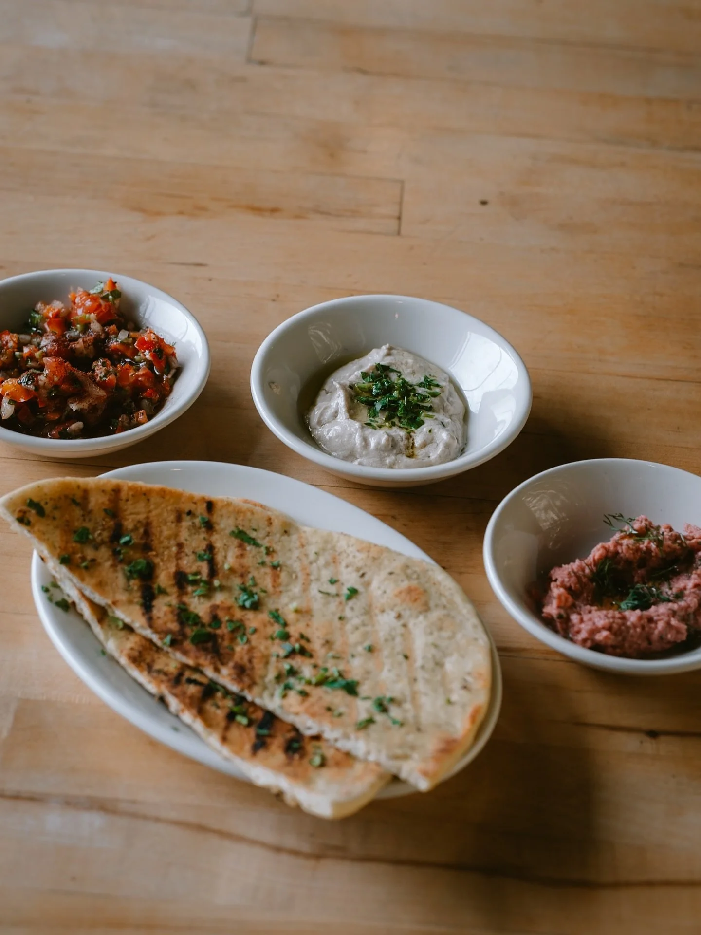 Tunisian Grilled Flatbread + Spreads

Zatar &amp; oil brushed on flatbread

Chickpea sauerkraut: made in house with beets, cabbage, apple &amp; carrots in sauerkraut, then blended with chickpeas, dijon, and dill

Tashi: tahini, lemon juice, garlic, w