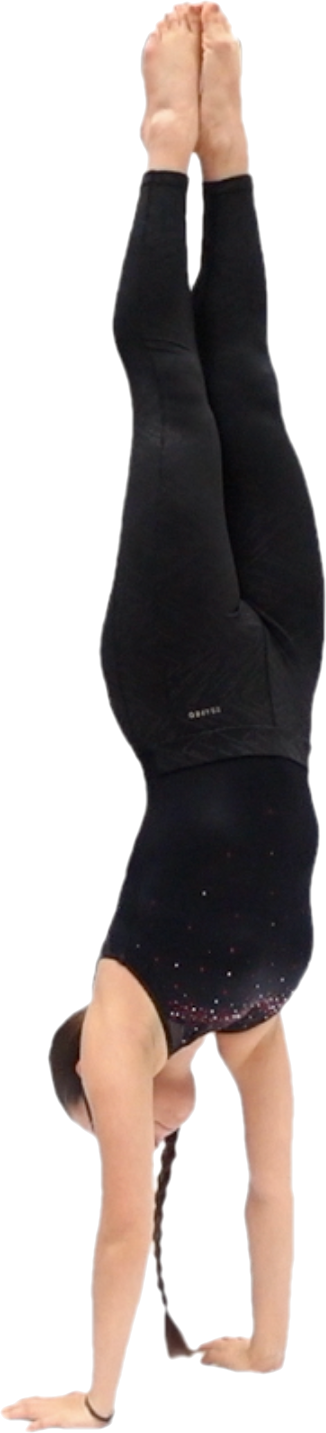 A person performing a handstand with legs extended upward and head toward the ground, wearing a black tank top and black leggings.
