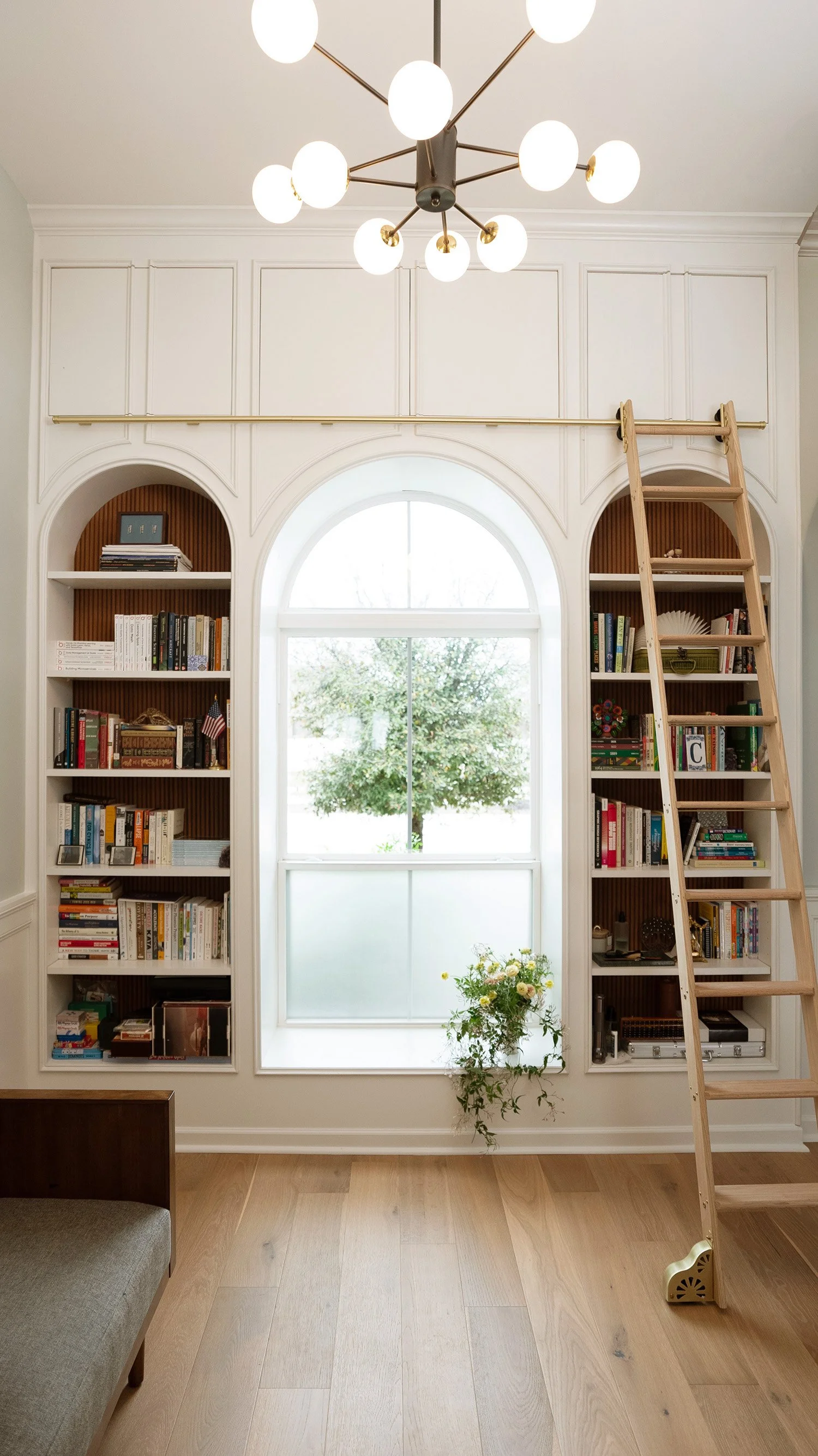 custom arched library designed and built around the home's existing architecture